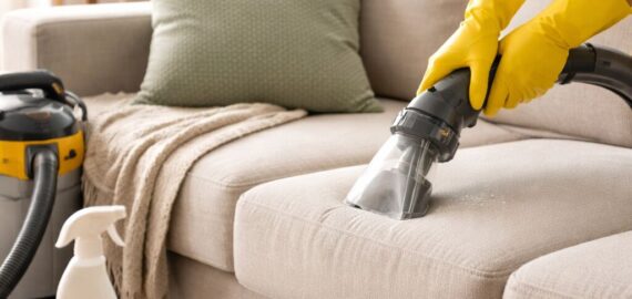 Cleaning the sofa in a bright living room Cleaning the sofa in a bright living room